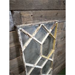 Four 19th century cast iron windows, lattice glazed in white painted finish, 