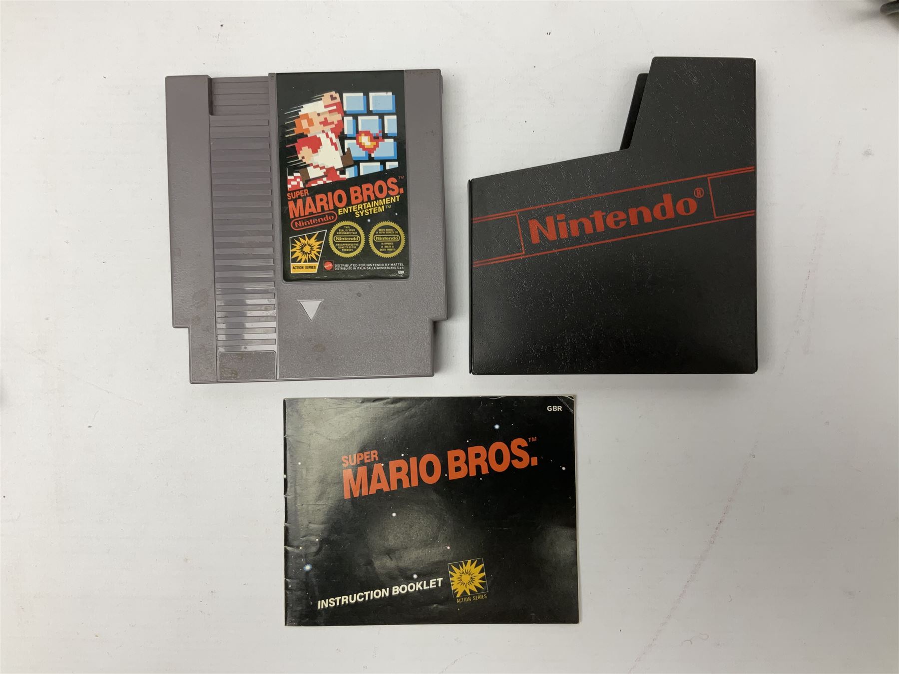 Nintendo Entertainment System (1985) console with two controllers, accessories and instruction booklet. NES Games ‘Duck Hunt’ with Nintendo Zapper gun, ‘Pinball’ and ‘Super Mario Bros.’, all with original sleeves and instruction booklets. NES game ‘Super Mario Bros. 2’ cartridge only