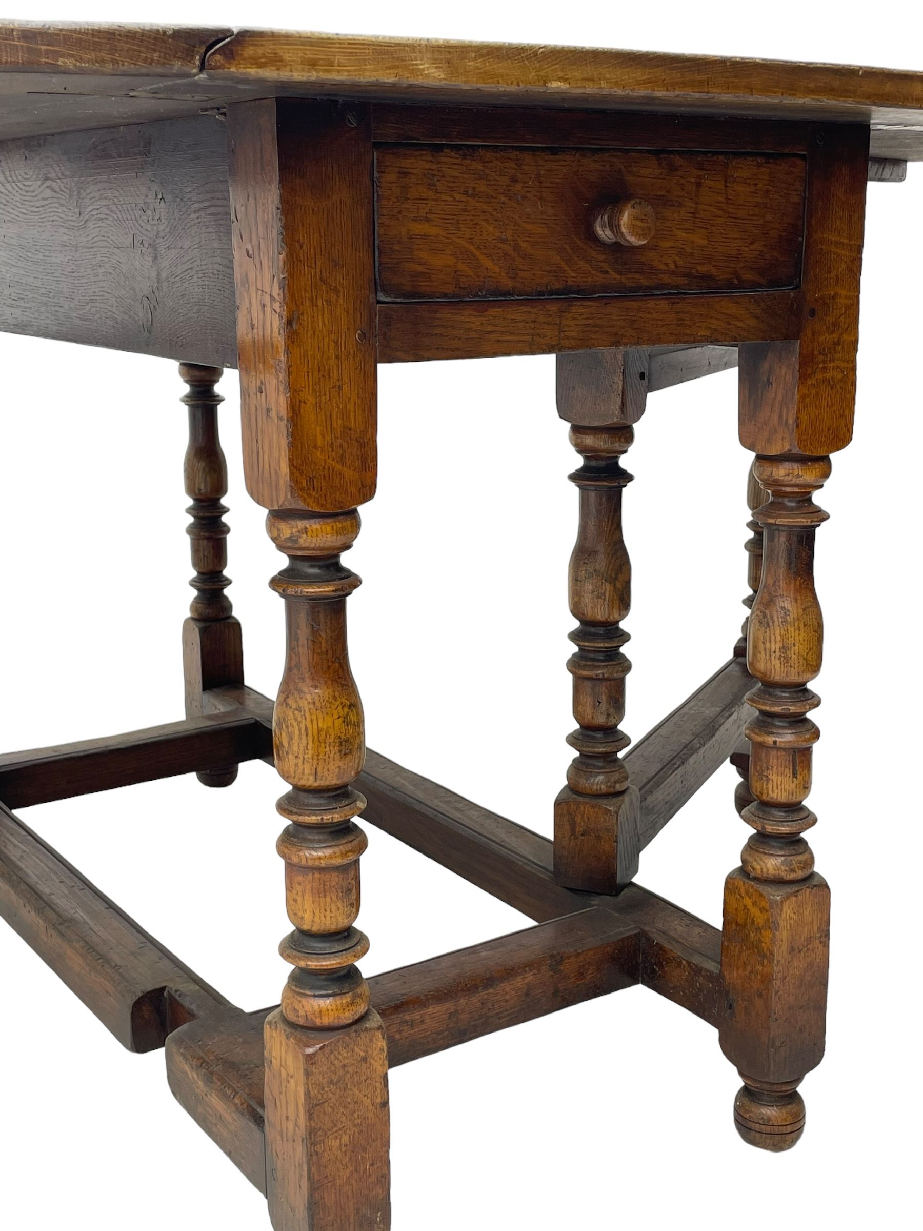 19th century oak dining table, oval drop-leaf top on gate-leg action base, turned supports united by turned stretchers, fitted with single end drawer