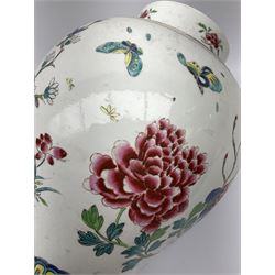 A large Chinese provincial style vase, of baluster form decorated with peonies, butterflies and birds upon a white ground, H35cm. 
