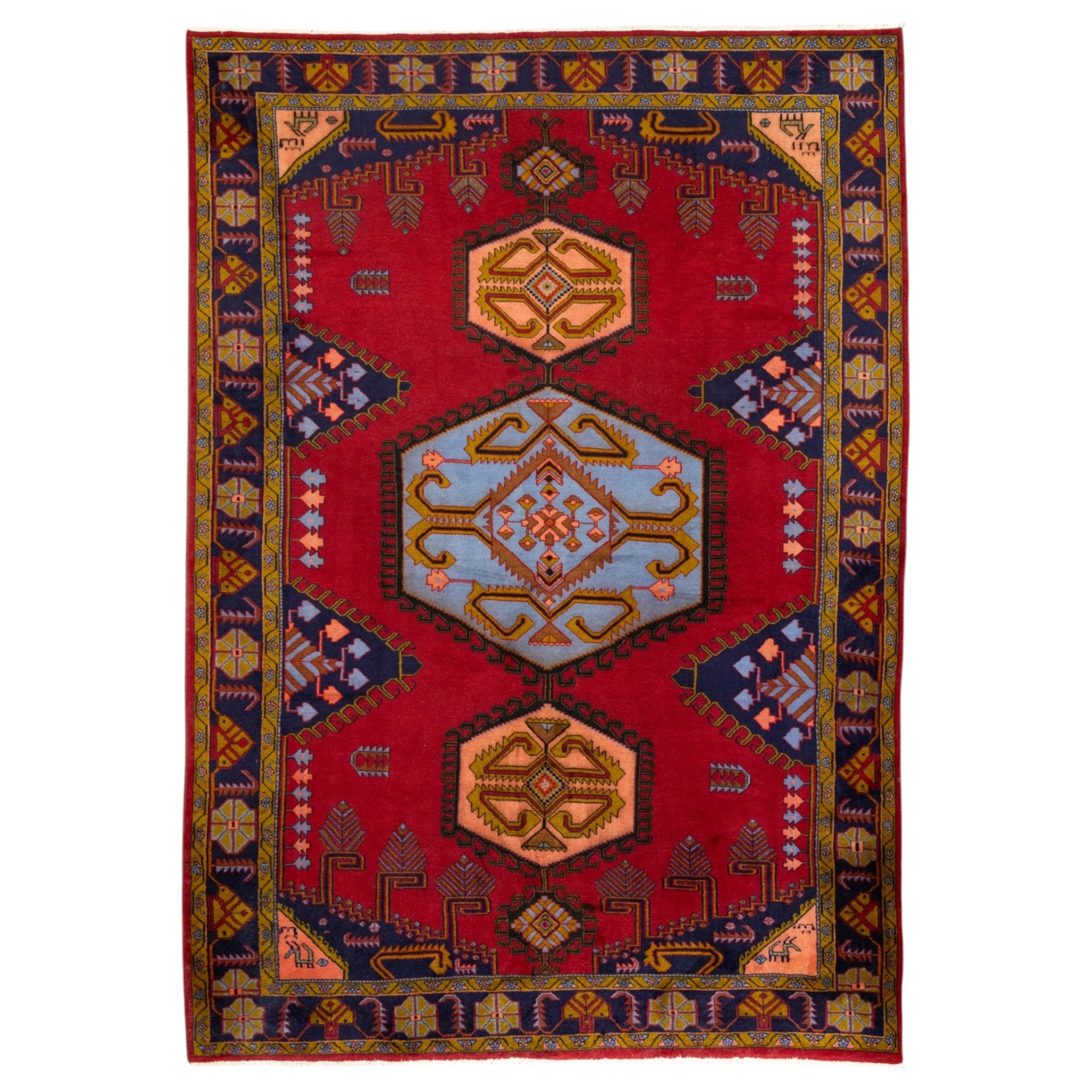 Turkish Anatolian hand-knotted carpet, red field centred by a large pale blue geometric medallion flanked by pink octagonal medallions, scattered stylised motifs, enclosed by multiple geometric borders