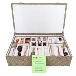 Boxed set of Chinese miniature polished hardstone musical instruments with hardwood stands