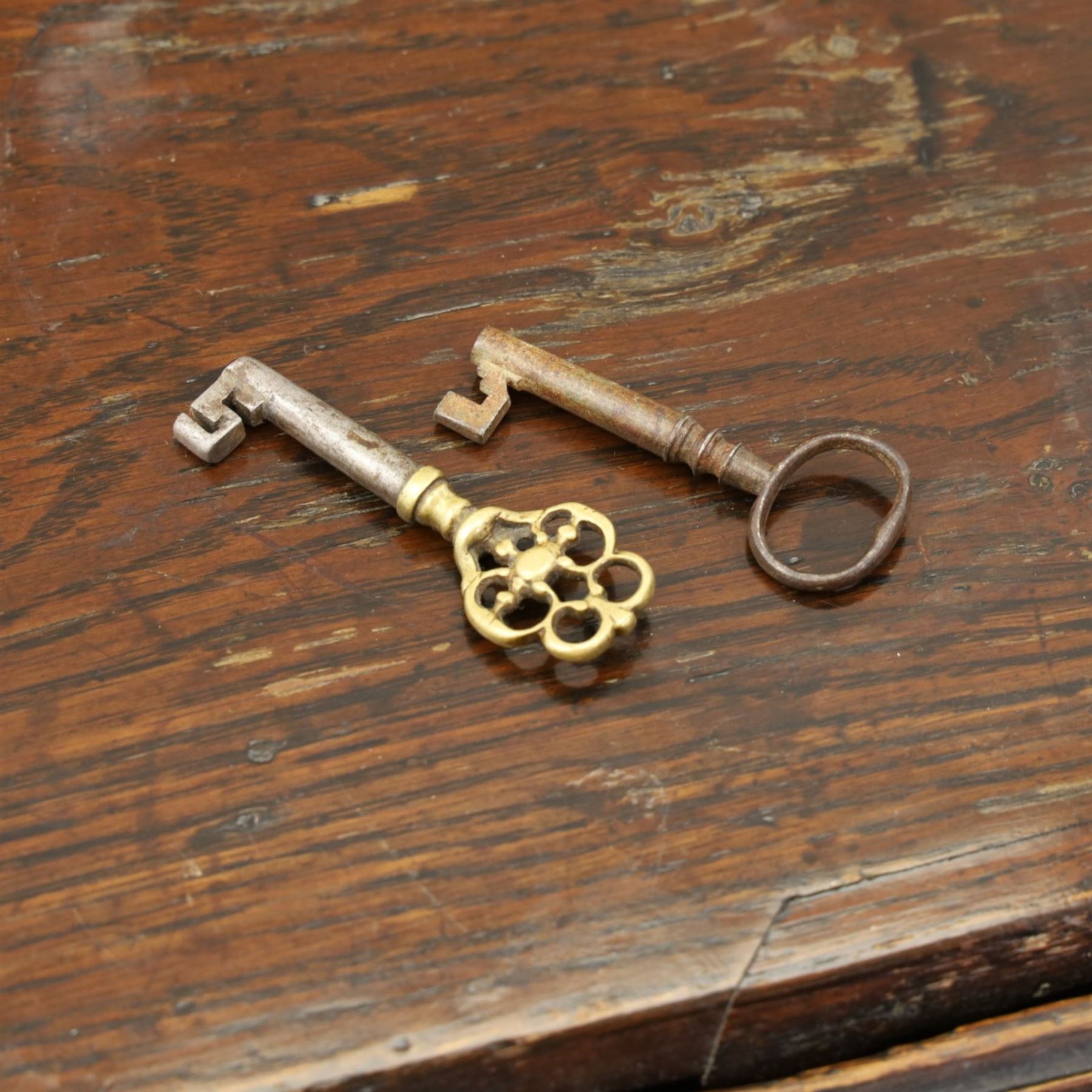 Georgian oak bureau, fall front with pierced brass escutcheon and handles, revealing a fitted interior, above two short over two long drawers, raised on bracket feet