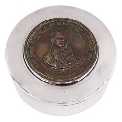 1920s silver box, of plain circular form, the removable cover set with copper medallion depicting William Wilberforce and commemorating the abolishment of the slave trade by act of parliament in 1807, the reverse of the medallion visible to the underside of the cover depicting the birth place of William Wilberforce, hallmarked George Unite, Birmingham 1927, H3cm, D7cm