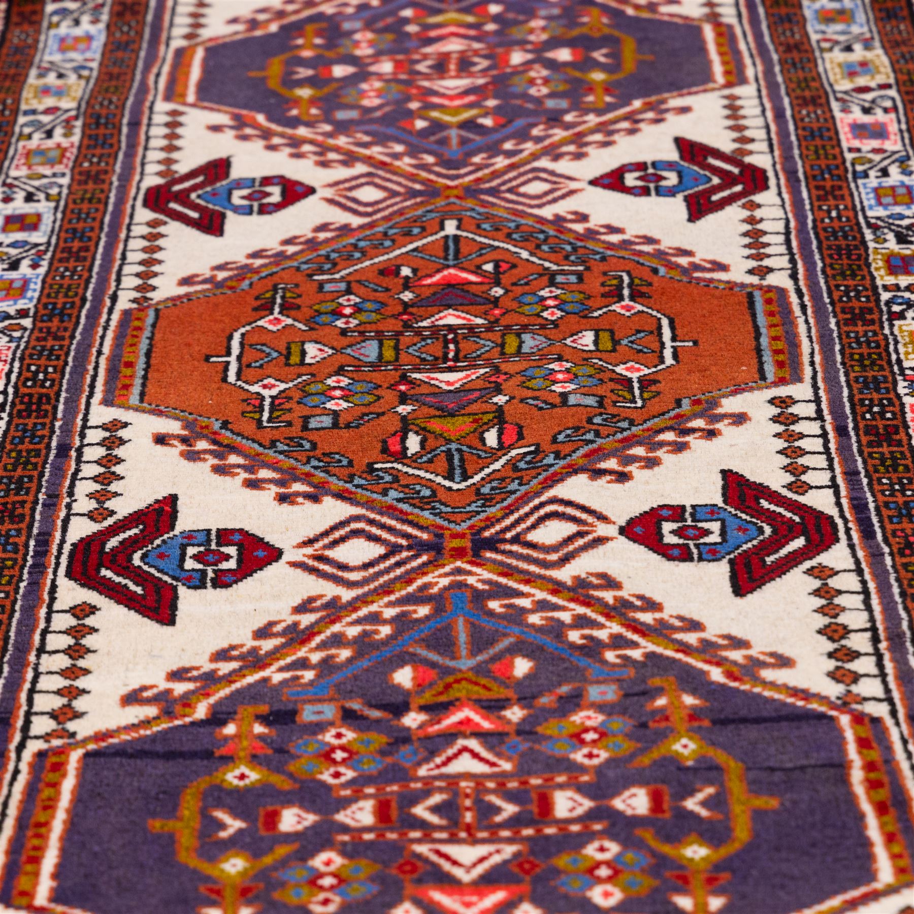 North West Persian Ardebil hand-knotted runner, ivory field decorated with row of large hexagonal medallions enclosing stylized geometric and floral motifs, linked by angular devices, within multiple geometric borders, cotton fringe ends 