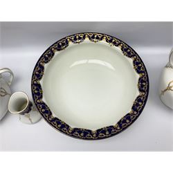 Early 20th century Bishop and Stonier four piece toilet set, comprising washbowl, wash jug, toothbrush pot, and chamber pot, each  decorated with deep blue band and husk swags and festoons in gilt, with printed Caduceus Bisto marks beneath and printed retailers mark 'Manufactured for Harrods Limited London', wash bowl D43cm, wash jug H31.5cm