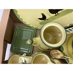 Zeller Fayencerie dinner and tea wares, decorated in cockerels against a yellow ground, with green scalloped border, comprising cake stand, two plates, bowl, three large teacups and saucers, coffee pot, milk jug, cream jug, lidded sugar bowl, pair of cruets modelled as cockerels, butter dish and cover, and utensils pot, and four similar egg cups, in one box 