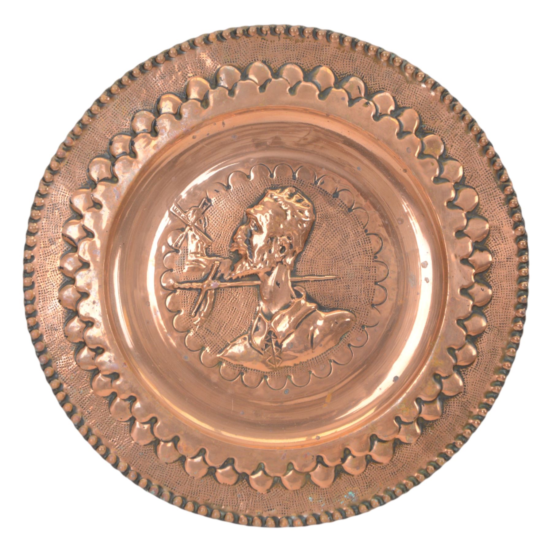 Two Spanish copper  charger decorated with Don Quixote, together with another copper dish  