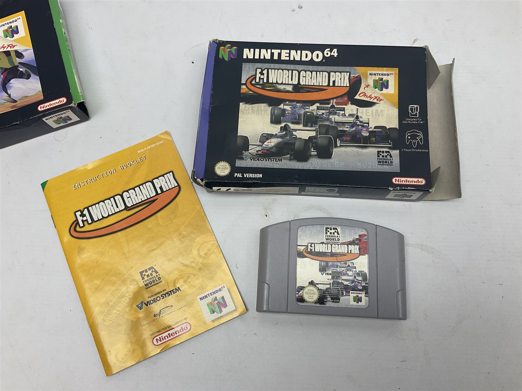 Nintendo 64 console, two controllers, games and accessories. Accessories to include the ‘Tremorpak’ and ‘Spook’ 2 Phono plugs and a S-VHS plug with adapter, both in original boxes. Games to include ‘Golden Eye 007’, ‘Doom 64’, ‘Killer Instinct Gold’, ‘Tetrisphere’, ‘F-1 World Grand Prix’, ‘Pilotwings 64’ and ‘Lylatwars’ with ‘Rumble Pak’, all with original boxes and instruction manuals. ‘Star Wars Episode I Racer’ game cartridge in Shadows of the Empire box. 