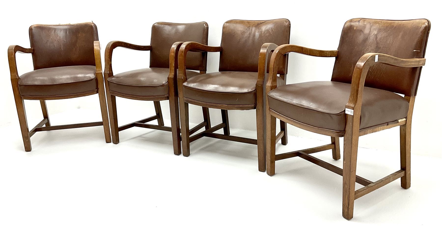Set four mid century oak framed boardroom chairs, upholstered back and seat, shaped arms, square tapering supports joined by stretchers