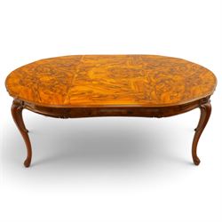 Dutch design figured walnut extending dining table, the shaped circular extending top with...