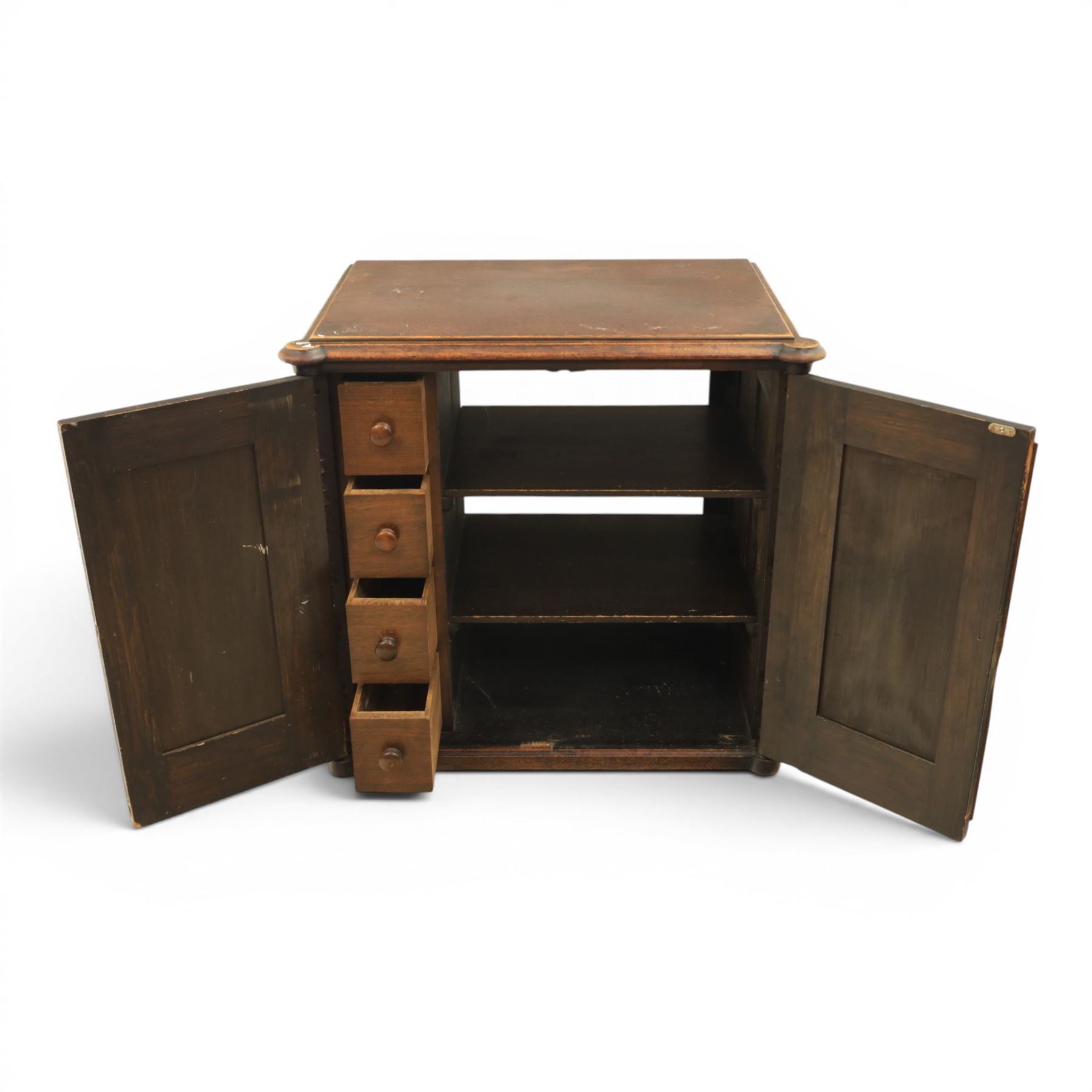 Victorian mahogany low cabinet, shaped rectangular top fitted with two arch panelled doors flanked by turned pilasters, enclosing two shelves and fitted with four short drawers with turned knobs 