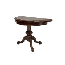 Victorian rosewood serpentine tea table, shaped fold-over and swivel top, raised on egg and dart carved baluster pedestal terminating in four scroll carved cabriole splay supports
