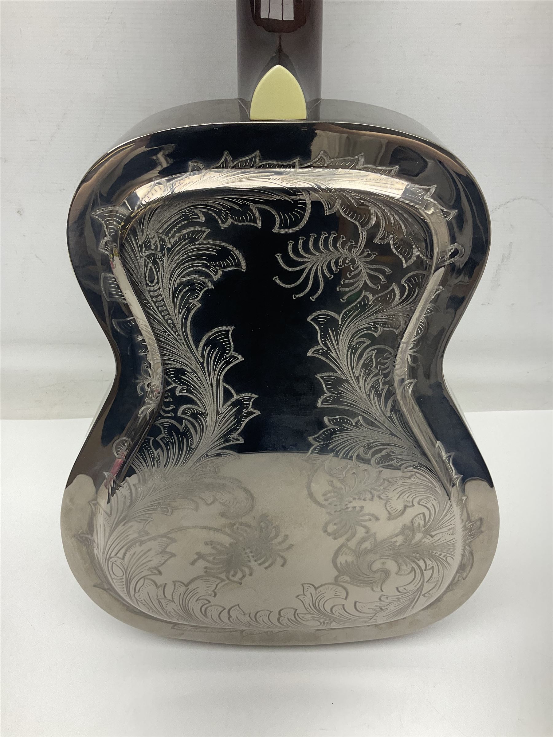 Ozark metal cased resonator guitar with all over chased foliate decoration to the polished finish and mother-of-pearl inlay to the fretboard L100cm; in Stagg hard carrying case