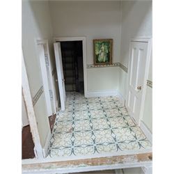 Two modern three storey dolls houses, each painted green with decorated interiors, both upon a single white wooden base, together with a large collection of dolls house furniture, accessories and figures 