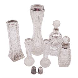 Four early 20th century cut glass vases with silver collars, to include a pair of bud vases, together with two cut glass scent bottles with silver collars and two silver thimbles, one example by Charles Horner, all hallmarked, tallest vase H19cm