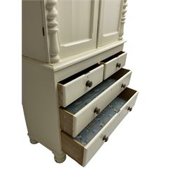 Victorian cream painted pine cupboard-on-chest or housekeeper's cupboard, projecting cornice over two double-arch panelled cupboard doors enclosing two shelves, flanked by spiral turned uprights, base fitted with two short over two long drawers, on bun feet