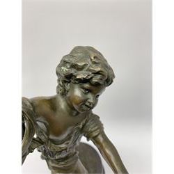 After E Plat, bronze modelled as a dancing child, signed E. Plat, upon cylindrical black marble base, H40cm