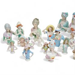 Collection of early 20th century ceramic half dolls, approximately 26, together with two novelty flasks in the form of ladies in evening dresses
