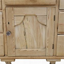 Victorian waxed pine farmhouse dresser, featuring seven drawers with central cupboard, moulded glass handles, raised on turned feet