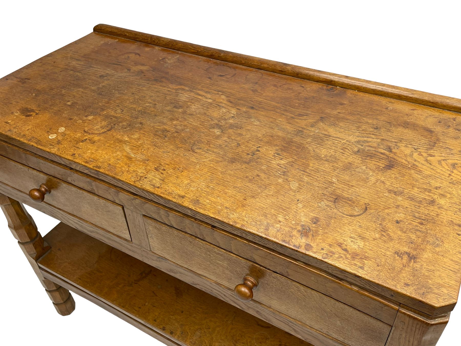 Mouseman - circa. 1950s oak serving table, adzed rectangular top over two drawers, on octagonal supports joined by adzed undertier, the rear right leg carved with mouse signature, by Robert Thompson of Kilburn