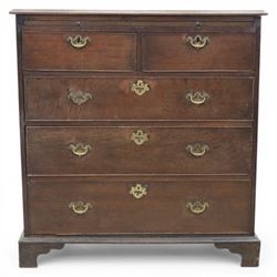 18th century oak chest, rectangular top with moulded edge, fitted with five drawers and baize line slide, with swan neck brass handles, raised on bracket feet