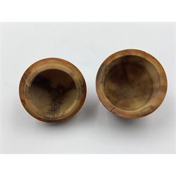 Three 19th century coquilla nut pomanders or flea catchers, two of egg shaped form and the third of barrel from with carved and pierced decoration and screw threaded join, largest H8cm