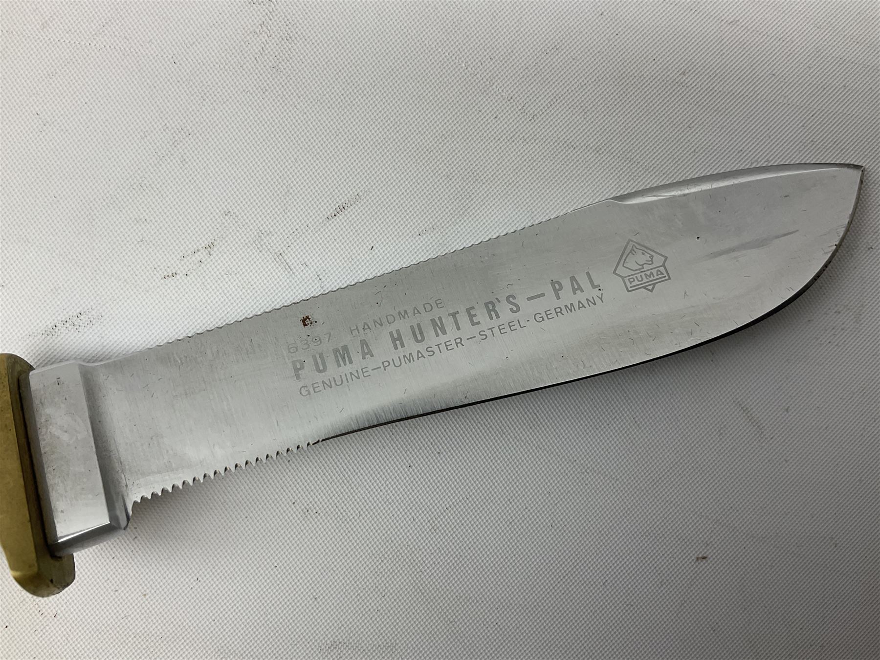 German Puma Hunter's-Pal knife, the 10cm steel blade marked model 6397, serial No.72573 to guard, fixed blade, antler scales; in original hard plastic case with paperwork and guarantee label; with brown leather sheath marked Puma L22.5cm overall