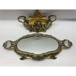 Ornate brass centrepiece, with twin handled vase upon a mirrored base, with floral and scrolling decoration, H23cm 