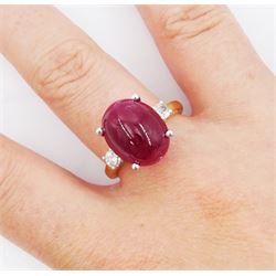 18ct gold ruby and diamond three stone ring, oval cabochon cut ruby of approx 11.40 carat, with a single round brilliant cut diamond set either side, hallmarked