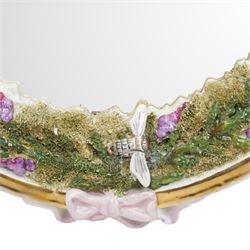 Sitzendorf oval table mirror with two cherubs holding a floral garland above foliage and insects etc on easel stand 40cm x 31cm