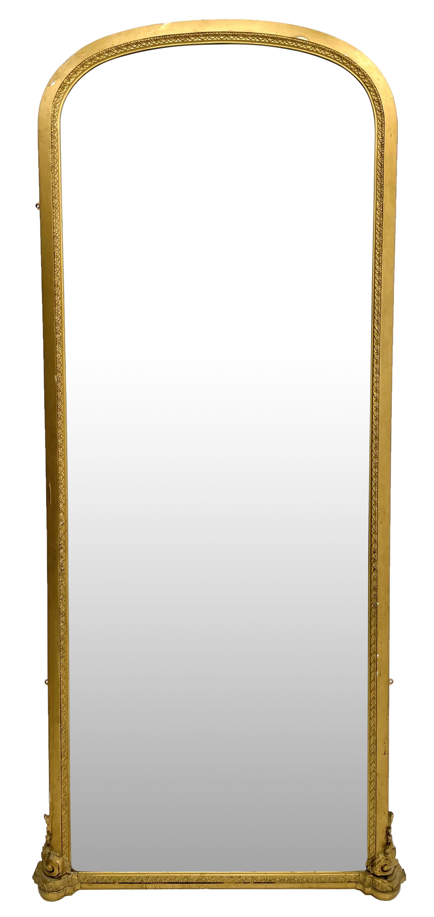Tall Victorian hall mirror, in arched gilt frame with foliate mould slip, acanthus scroll corner brackets 