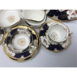 Coalport cobalt blue batwing pattern tea wares, decorated with finely enamelled floral sprays within gilt reserves, comprising teacup trio, coffee can and saucer and other cup and saucer, twin handled cake plate, milk jug and open sucrier, and circular plate retailed by T. Goode & Co London, pattern no Y2665,  all with green Coalport AD 1750 marks beneath, largest W26cm (11)