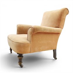 Victorian mahogany framed armchair of traditional shape, the high sprung rolled back over out-swept arms, deep sprung seat over turned feet with ceramic castors, upholstered in pale salmon pink fabric