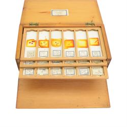 Early 20th century brass microscope, with black lacquer finish by C. E Baker of High Holborn, with lenses and plates contained within a wooden case, together with a collection of prepared microscope slides of predominantly histological and botanical specimens, contained within a wooden case