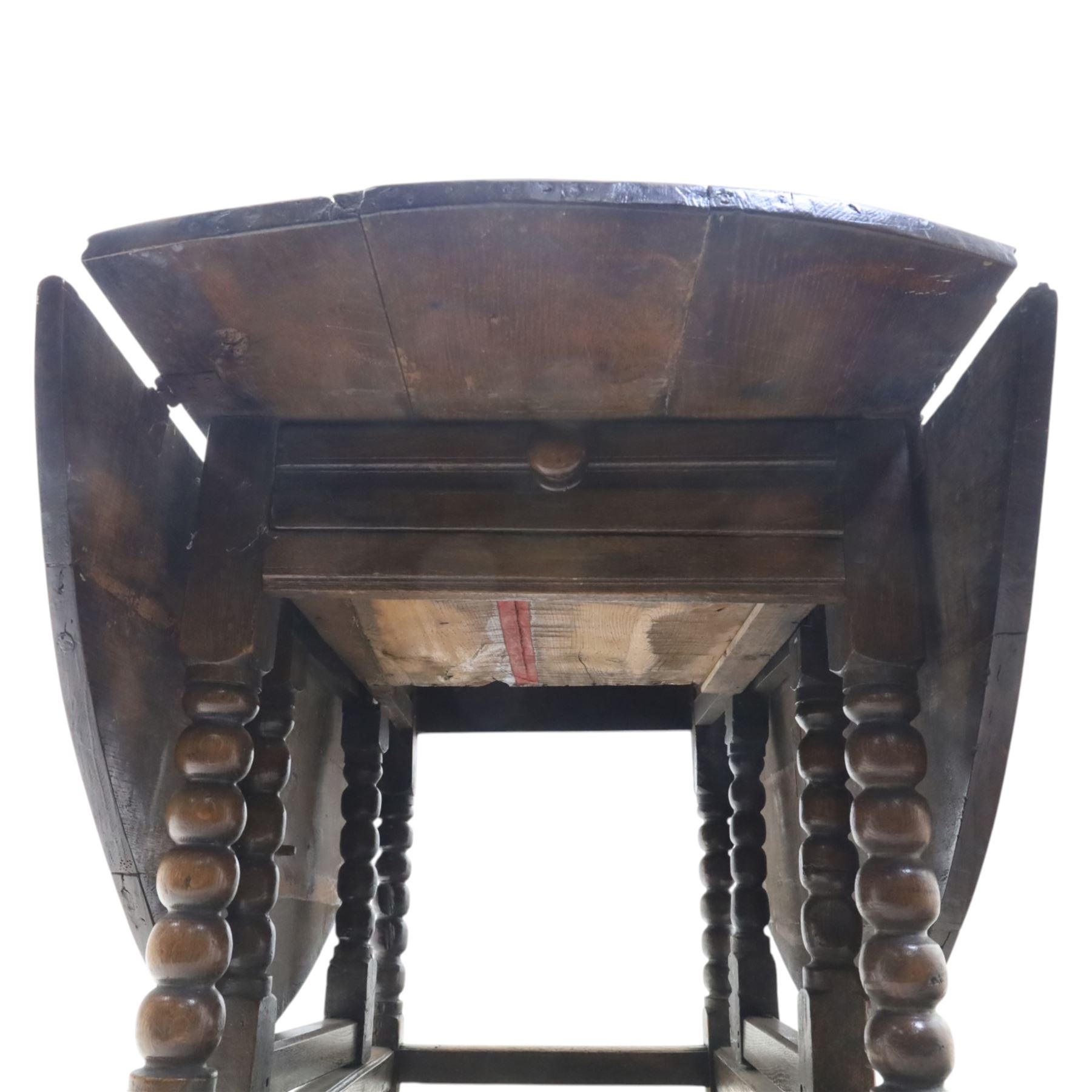 18th century country oak oval dining table, plank top with two drop leaves and gate-leg action, single drawer, raised on bobbin turned legs