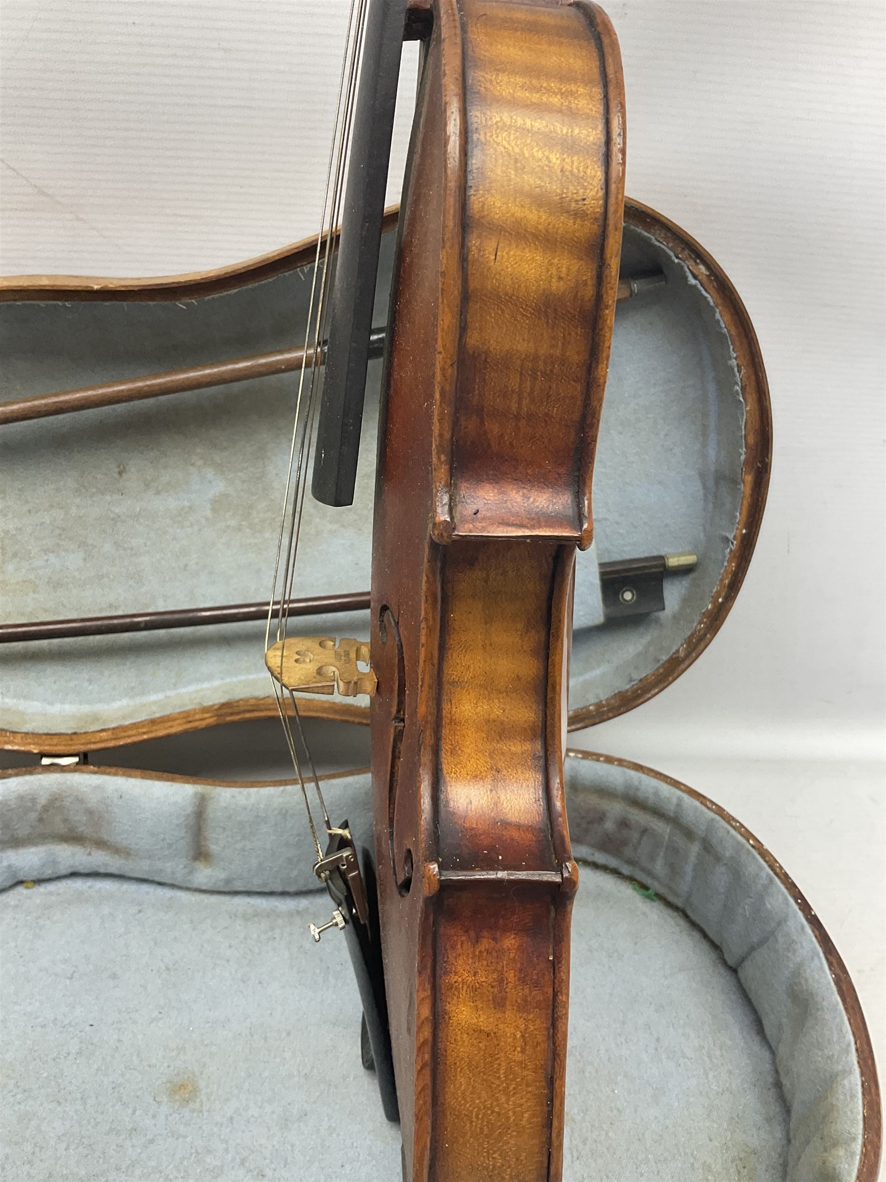 Mid-19th century German violin with 36cm two-piece maple back and ribs and spruce top, bears label 'Riccardo Antoniazzi Cremonese fece in Milano l'anno 1896' L59.5cm overall; in walnut case with two part bows