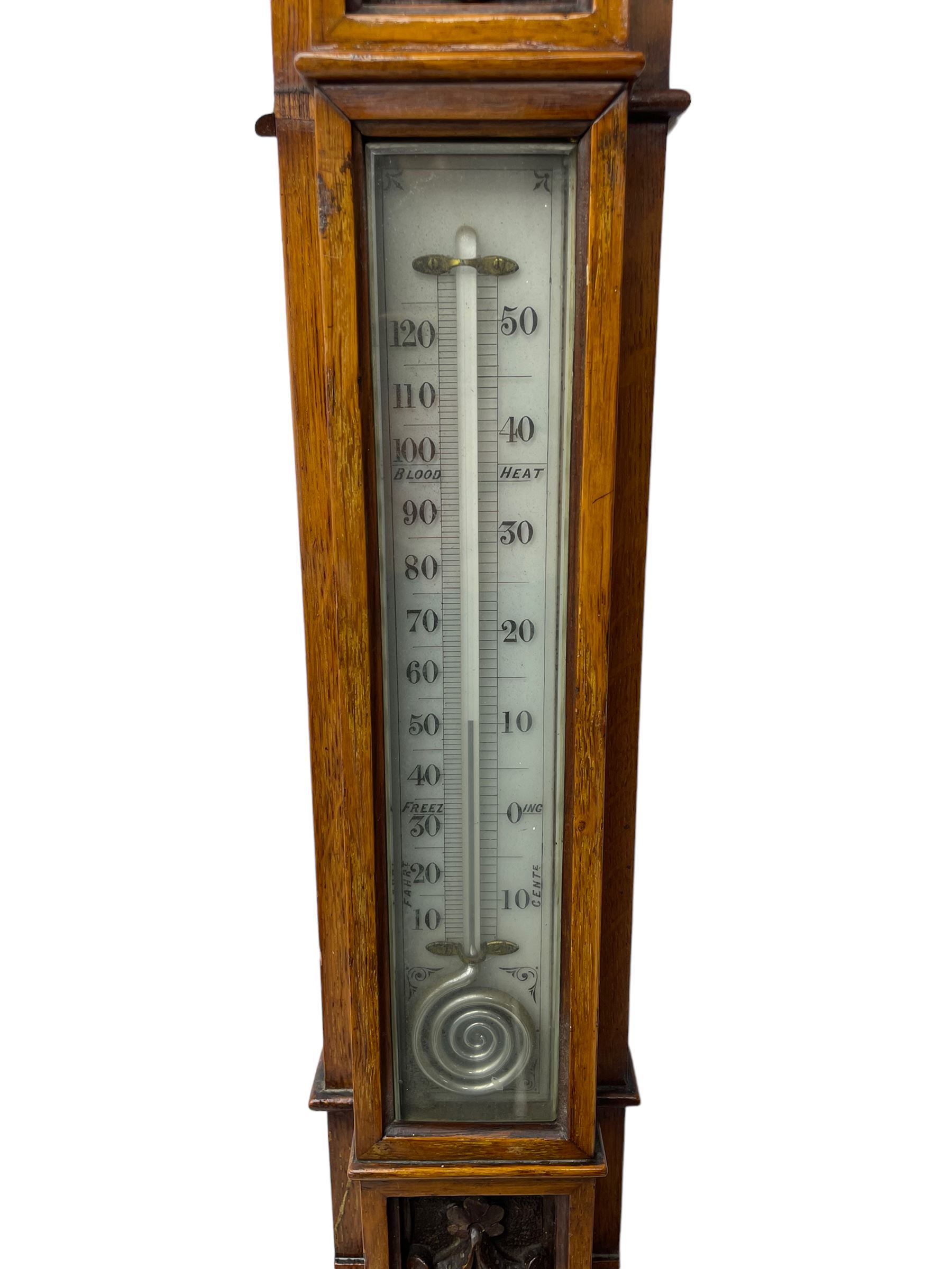 J Hicks - Hatton Garden London, - late 19th century carved oak cased Fitzroy barometer in a richly carved case with a carved crested pediment and square cistern cover, inverted opaline register reflecting FitzRoy's predictions and a scale from 27 to 31 inches of barometric pressure, with a thick bore cistern tube and adjustable rack and pinion twin vernier, fitted with a glazed snail bulb mercury thermometer recording the air temperature in both Fahrenheit and Celsius. Mercury clean and present.
James Joseph Hicks was born in Ireland, however, early in his life he moved to London where he was apprenticed to the instrument maker Louis P Casella. In 1860 he went into business in his own right as a scientific instrument maker at 8 Hatton Gardens. In 1864 he was granted membership to the British Meteorological Society and exhibited instruments at the Royal Society Exhibitions between 1876 and 1913. Hicks was one of London's most prolific and eminent barometer makers. 