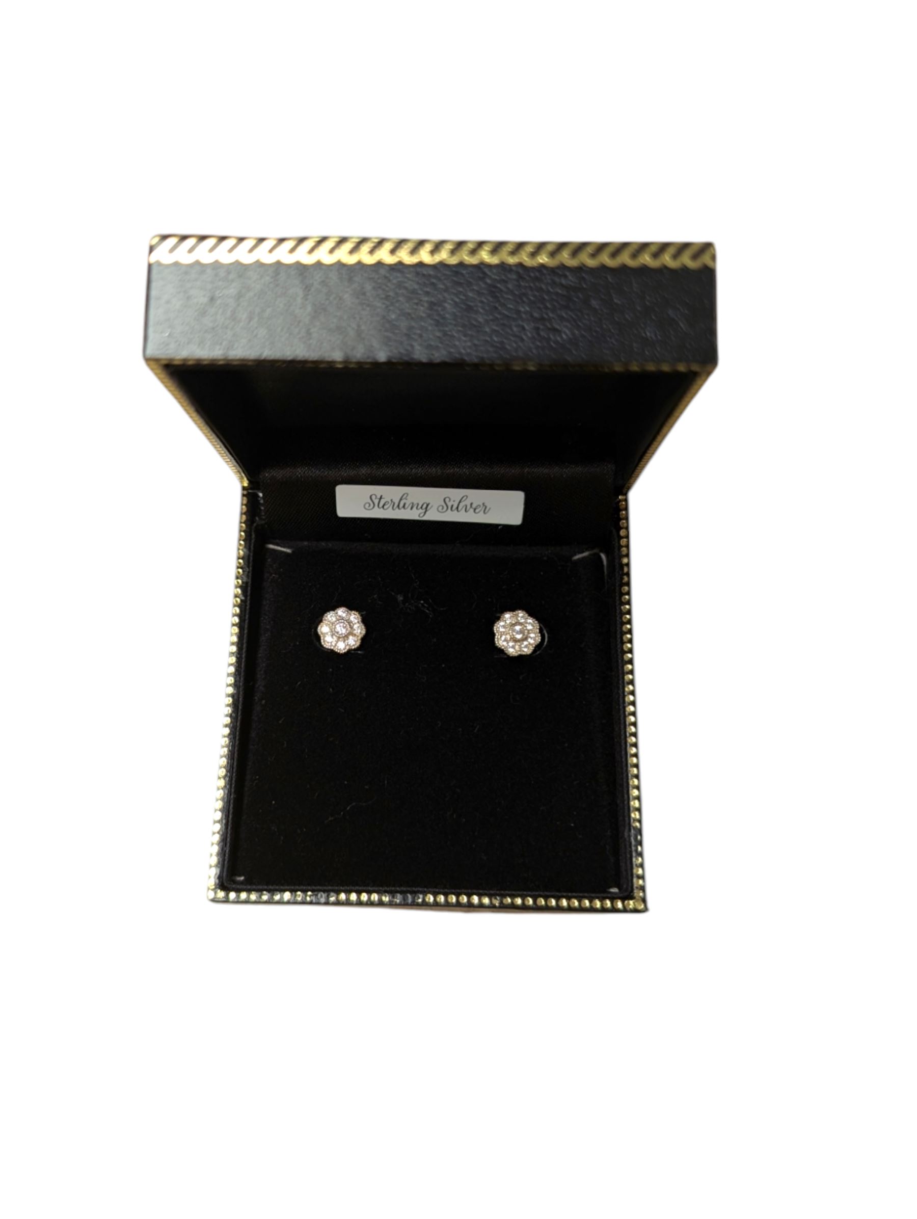 Pair of silver cubic zirconia flower stud earrings, boxed