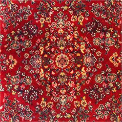 Persian Isfahan-style hand-knotted rug, crimson ground, with an intricated all-over floral spray design with palmettes and leaves, wide midnight blue main border with rosette and palmette motif, flanked by narrow guard borders  