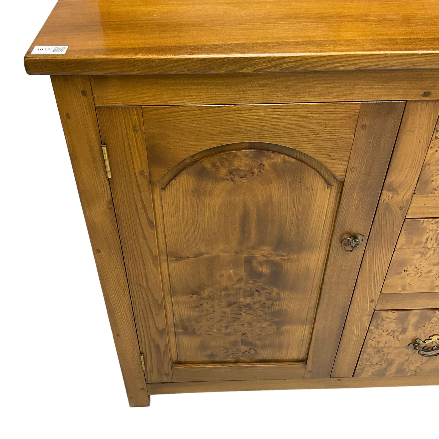 David Shackleton of Snainton - highly figured elm dresser, projecting moulded cornice over raised display cabinets and shelves, the base fitted with three central drawers and flanked by panelled cupboards, inscribed 'DS 1990'