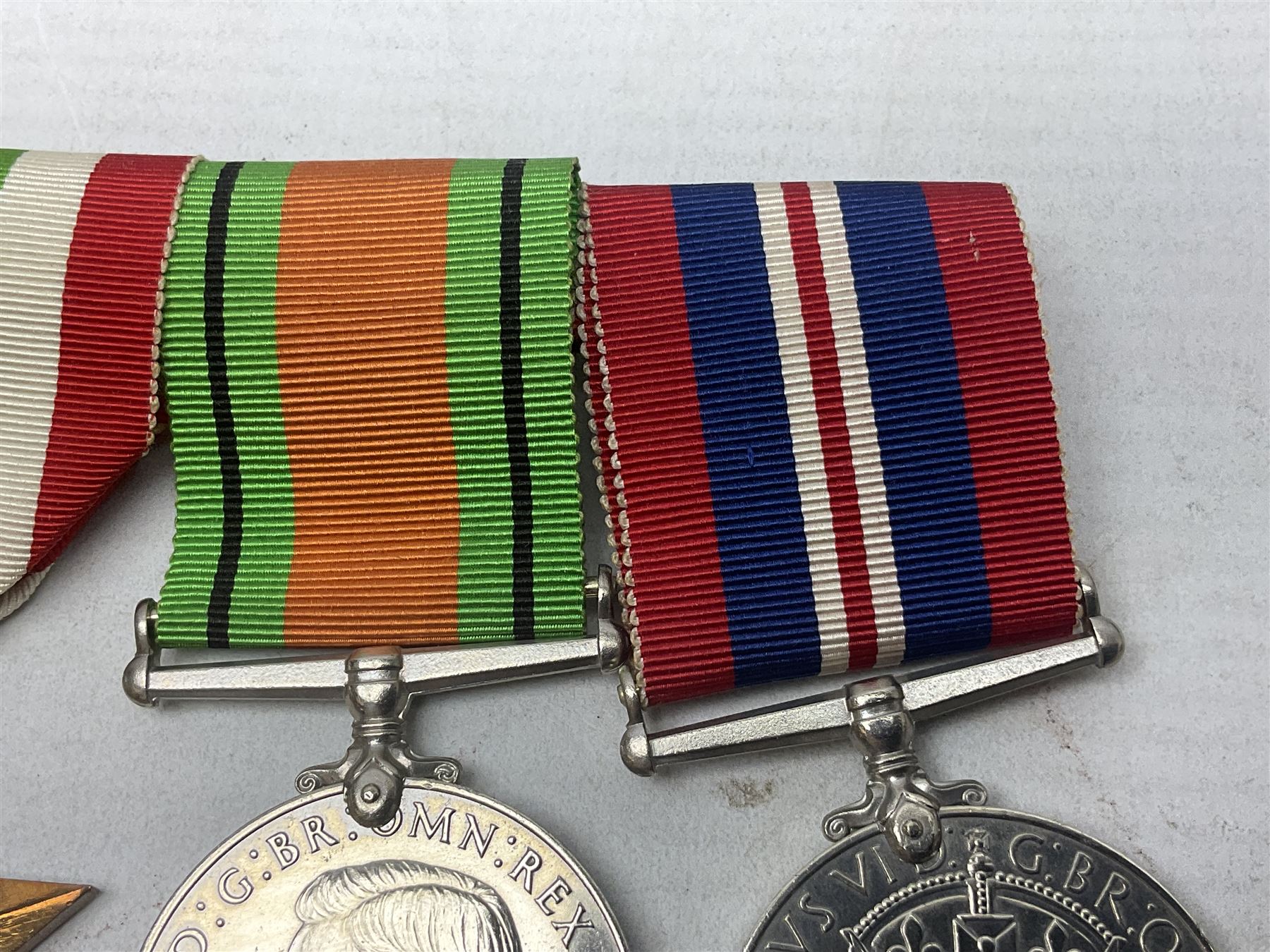 WW2 group of four medals comprising 1939-1945 War Medal, Defence Medal, Italy Star and 1939-1945 Star; with Royal Army Service Corps cap badge and RASC chrome and enamel sweetheart brooch