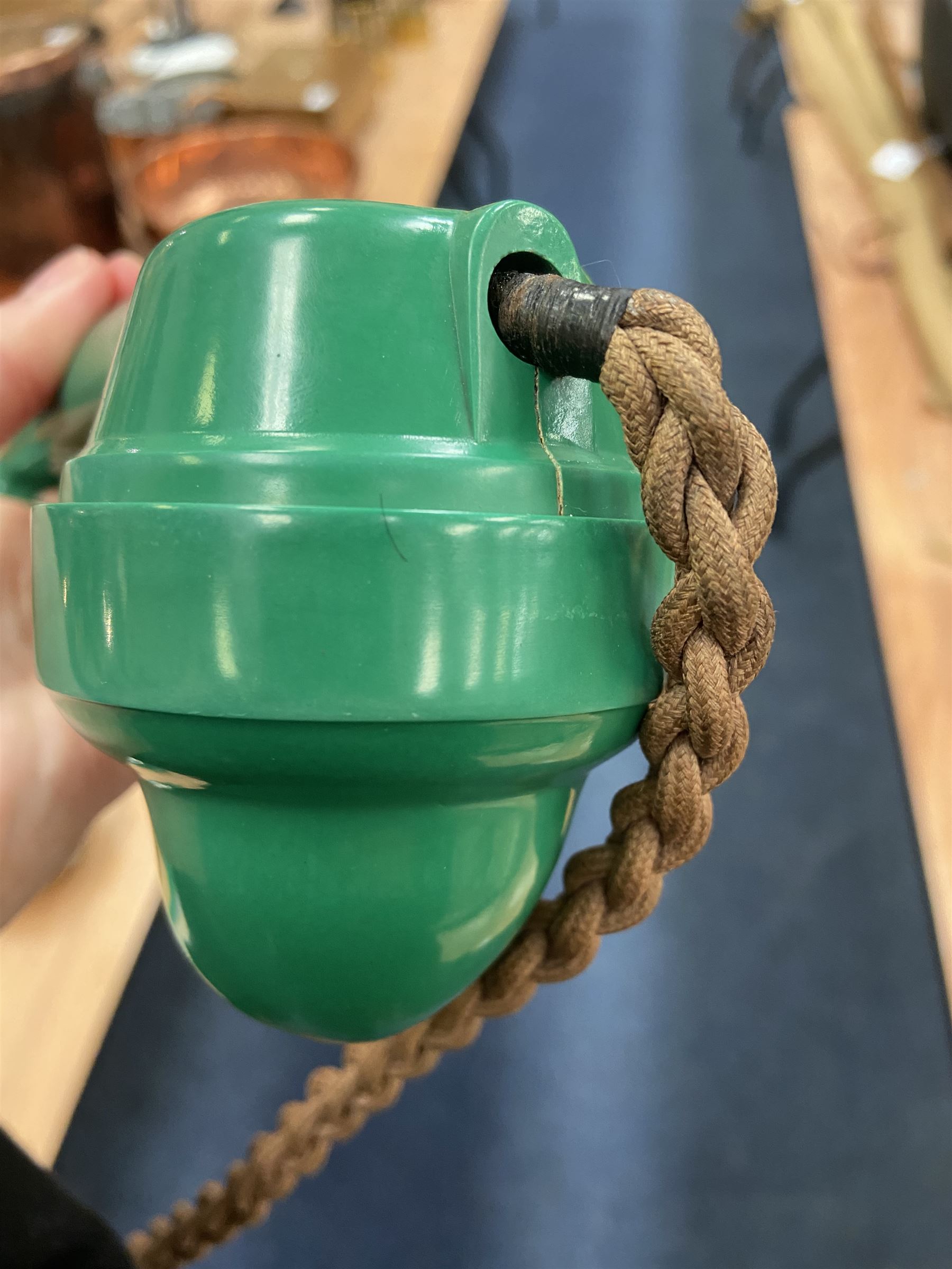 Jade green Bakelite telephone, of pyramid form with alphabet dial, brown braided handset cord and a base draw