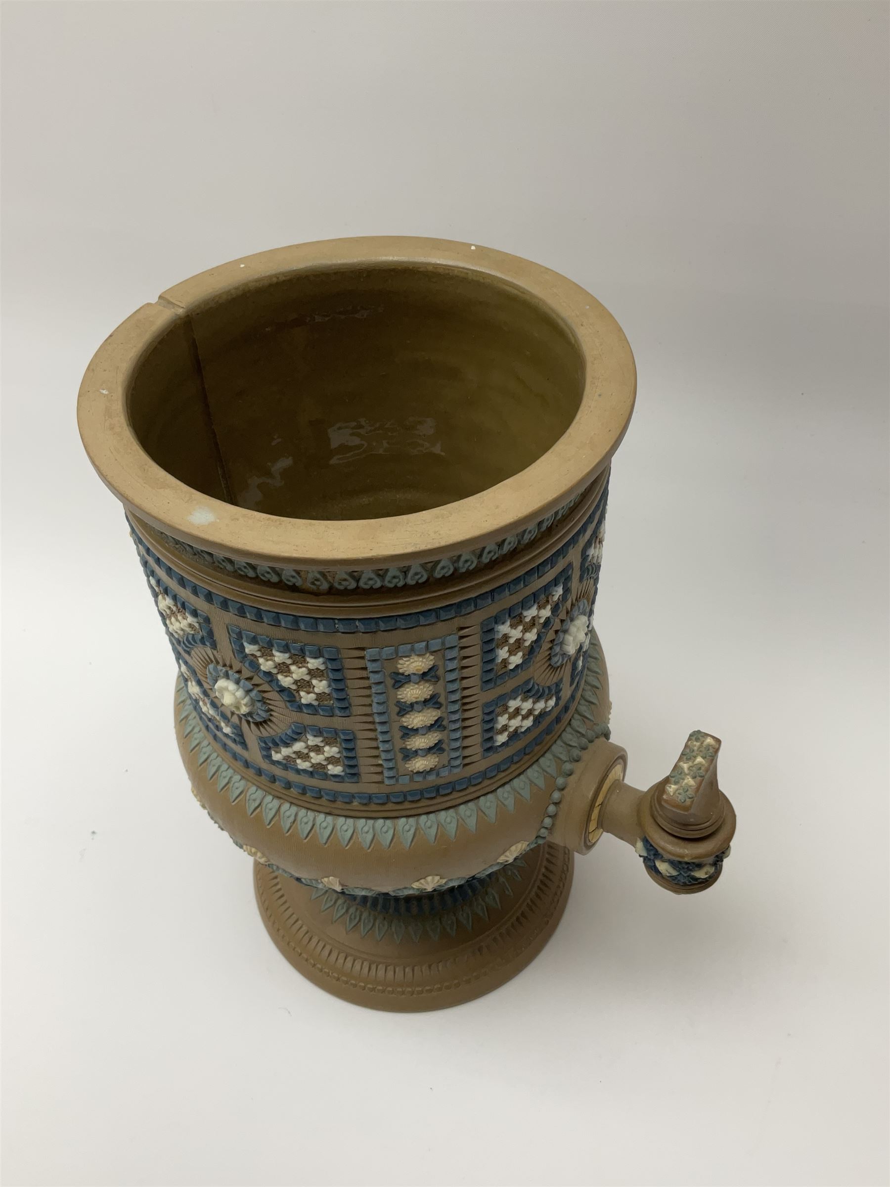 A late 19th century Doulton Lambeth stoneware water filter with original spigot, decorated with relief moulded foliate bands, with impressed marks and monogrammed for Laura Gooderham beneath, H34cm. 
