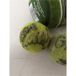 Three tennis balls, two with indistinct signatures, in Wimbledon Lansons Champagne cooler case