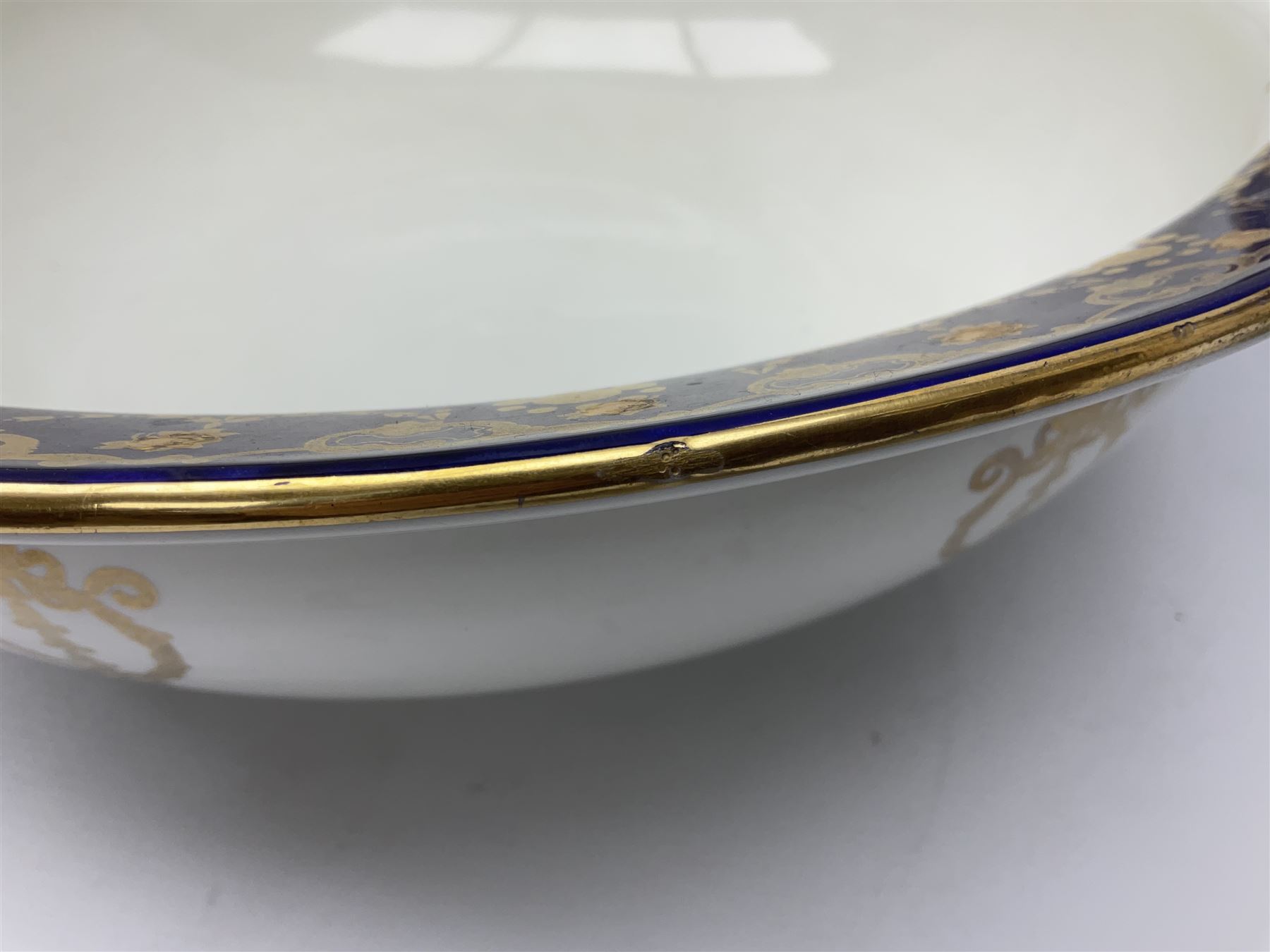 Early 20th century Bishop and Stonier four piece toilet set, comprising washbowl, wash jug, toothbrush pot, and chamber pot, each  decorated with deep blue band and husk swags and festoons in gilt, with printed Caduceus Bisto marks beneath and printed retailers mark 'Manufactured for Harrods Limited London', wash bowl D43cm, wash jug H31.5cm