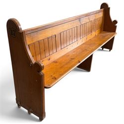 Early 20th century stained pine ecclesiastical church pew, the shaped end supports flanking slatted and panelled back, with black stencilled number '17' to the side