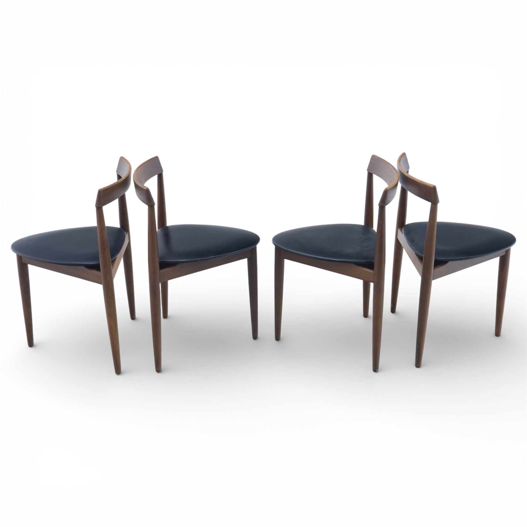 Frem Røjle - Danish teak 'Roundette' extendable dining table, circular top with softly chamfered edge and internal stowable leaf extends to 156cm, raised on four tapered cylindrical legs, accompanied by four matching dining chairs with shaped teak frames and black vinyl upholstered seats, the chairs designed to nest beneath the table when not in use