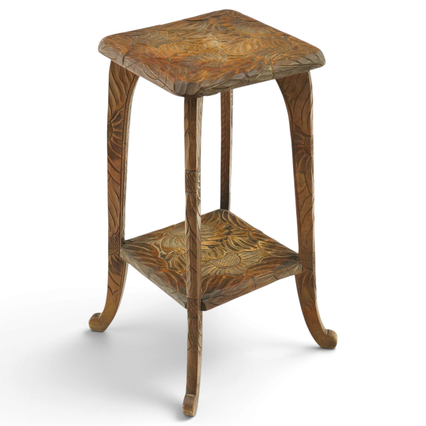 Attrib. Liberty & Co. - Arts & Crafts carved Japanese pattern two-tier occasional table, the square top with rounded corners heavily carved foliate motifs, raised on tapering supports with scroll feet united by undertier