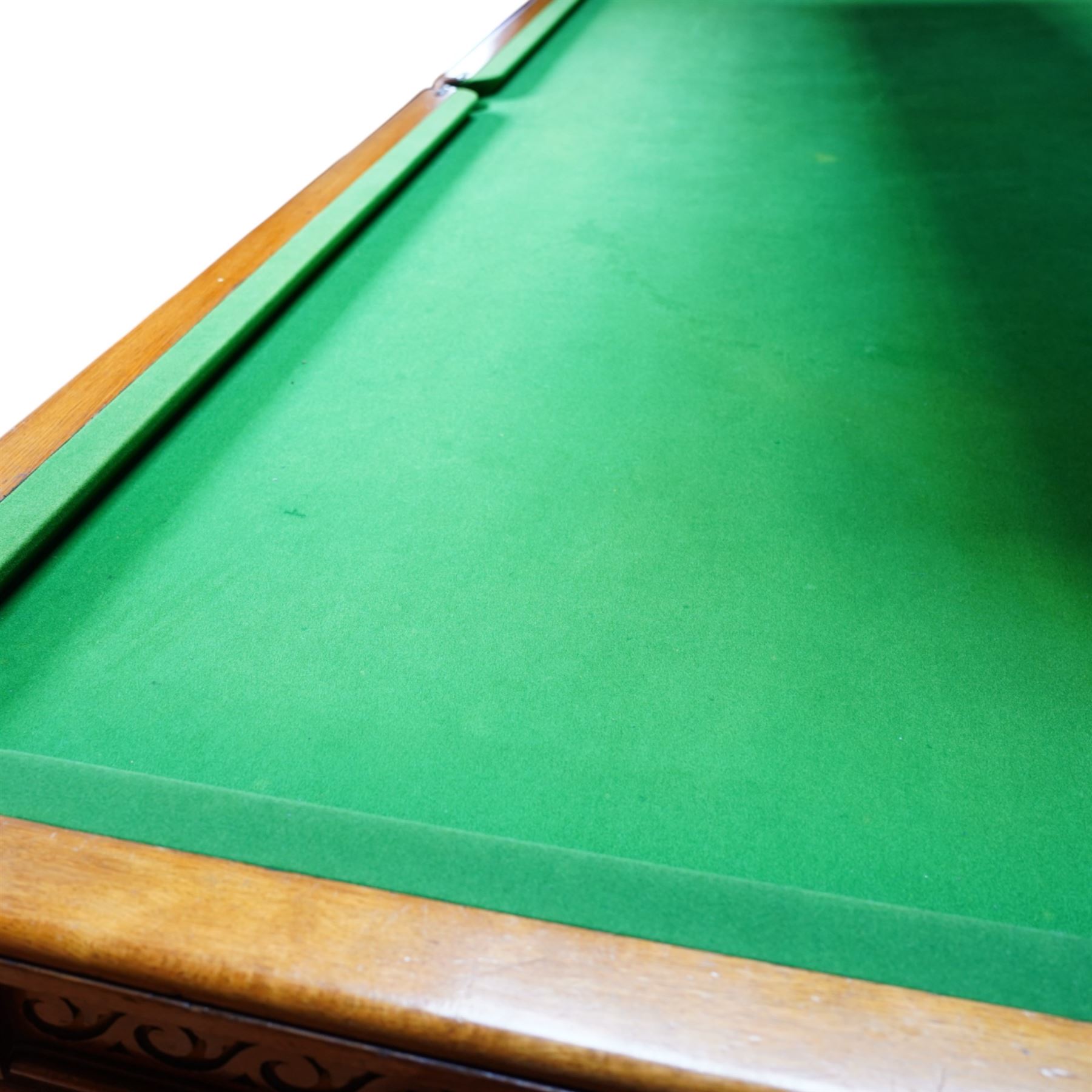 An outstanding bespoke late Victorian Aesthetic Movement golden oak full-sized snooker table of gothic influence, the rectangular slate bed covered in green baize within moulded rails and rounded pocket mounts, the protruding frame decorated with blind-fretwork frieze panels of Vitruvian scrolls and geometric ornament, over rails of repeating roundel carvings, raised on square chamfered and reeded supports with carved detail and panelled reserves, with further stylised brackets, stamped to the underside on all four edges R Anderson, serial number 4337
Viewing in situ near Tadcaster, please contact Chloe to arrange - 01904 393300
